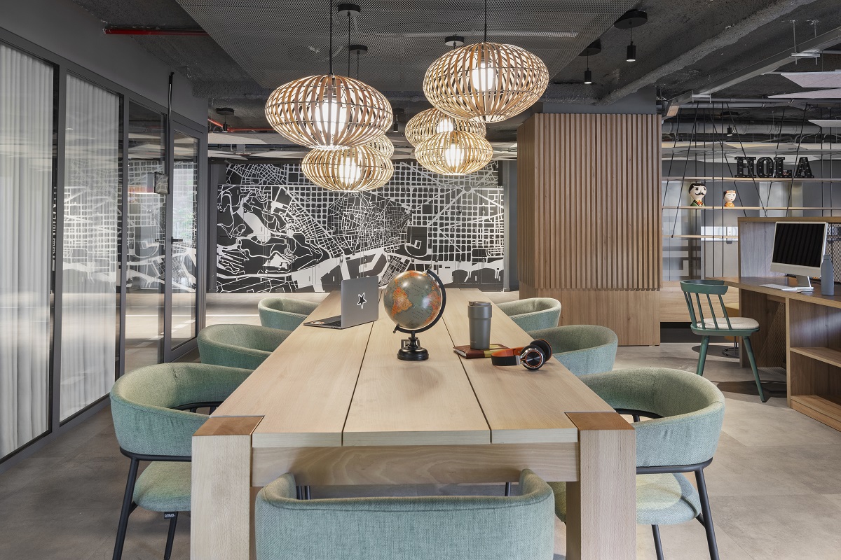 long wooden table in coworking space in Moxy Barcelona