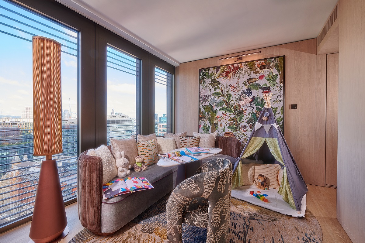 statement floor light, couches and childrens play area in family suite