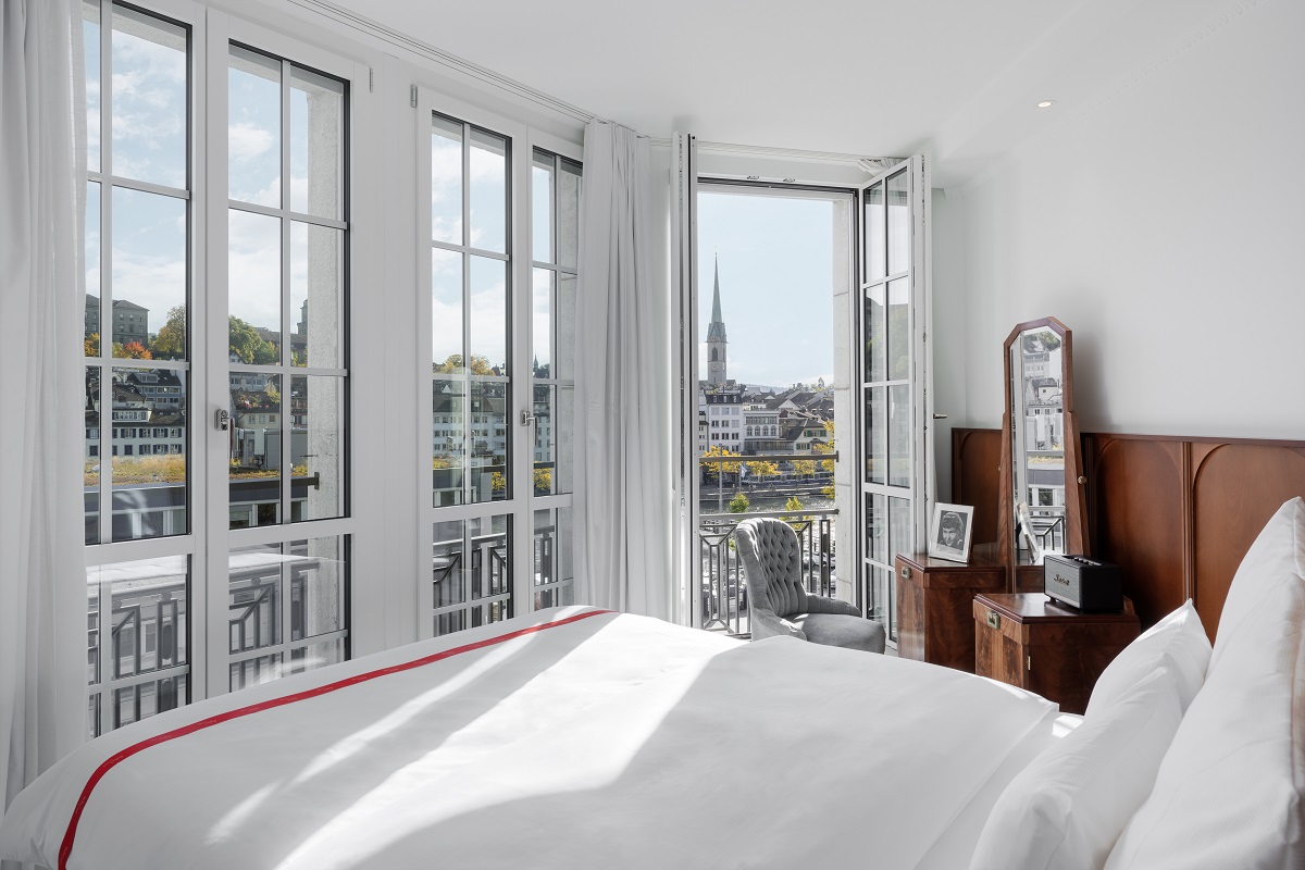 white bedroom with wood panels and white linen in Ruby Hotel