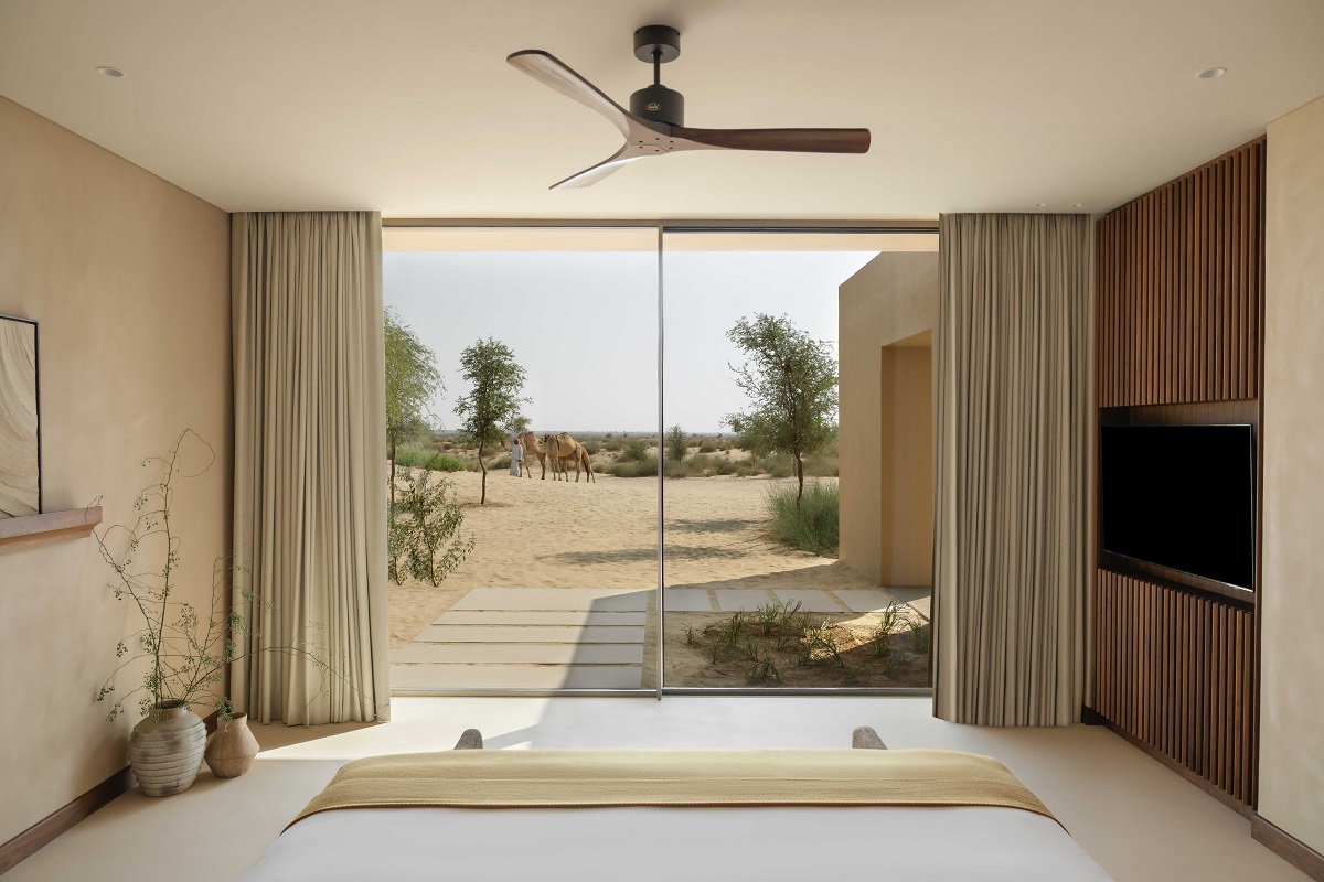 view from the bed in a villa at Bab Al Shams onto the desert