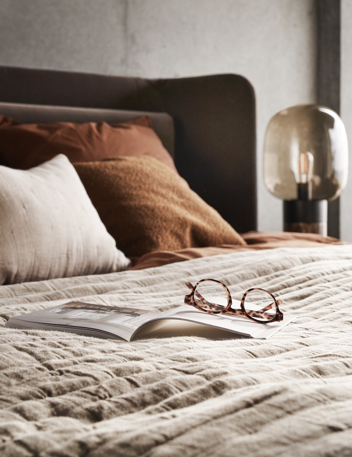 bedside lamp, soft linen book and glasses in BoConcept hygge design