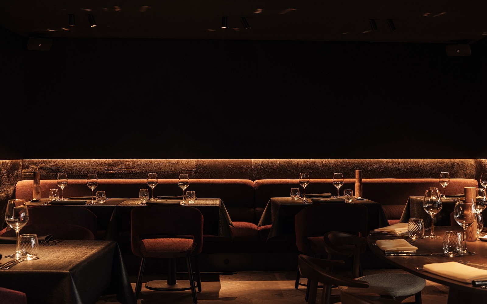 dark walls and back lit seating in Cult Bruges