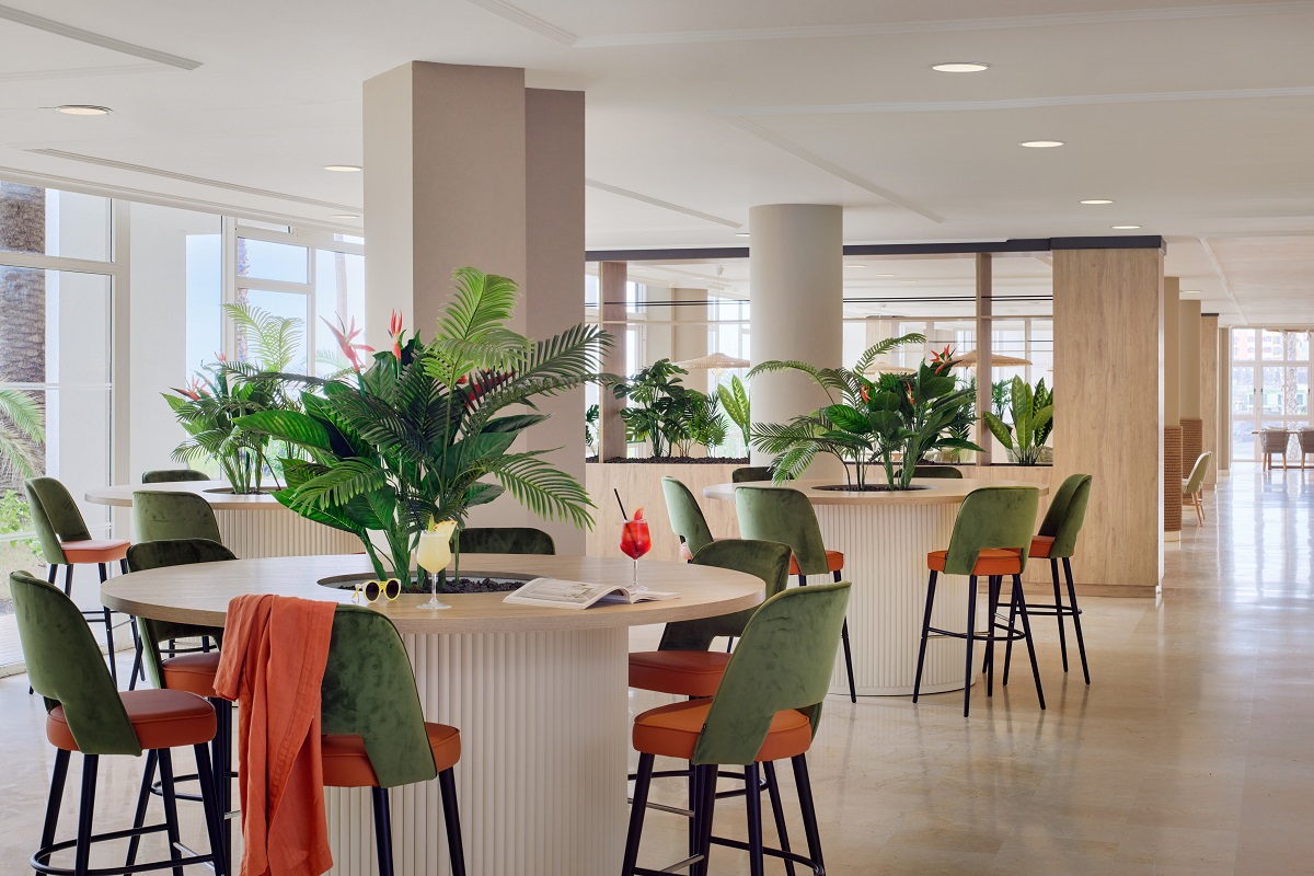 orange and green chairs reflect colour of foliage in restaurant Melia La Palma