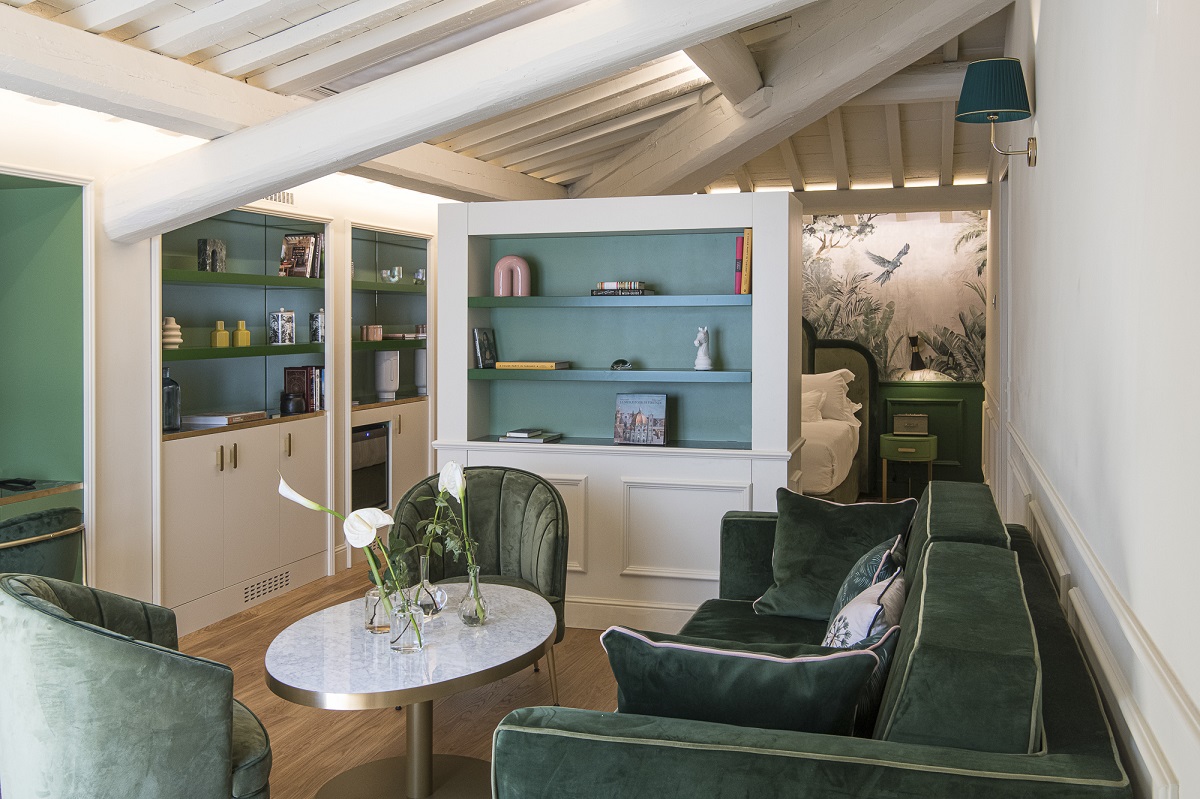 hotel guestroom with green velvet seating