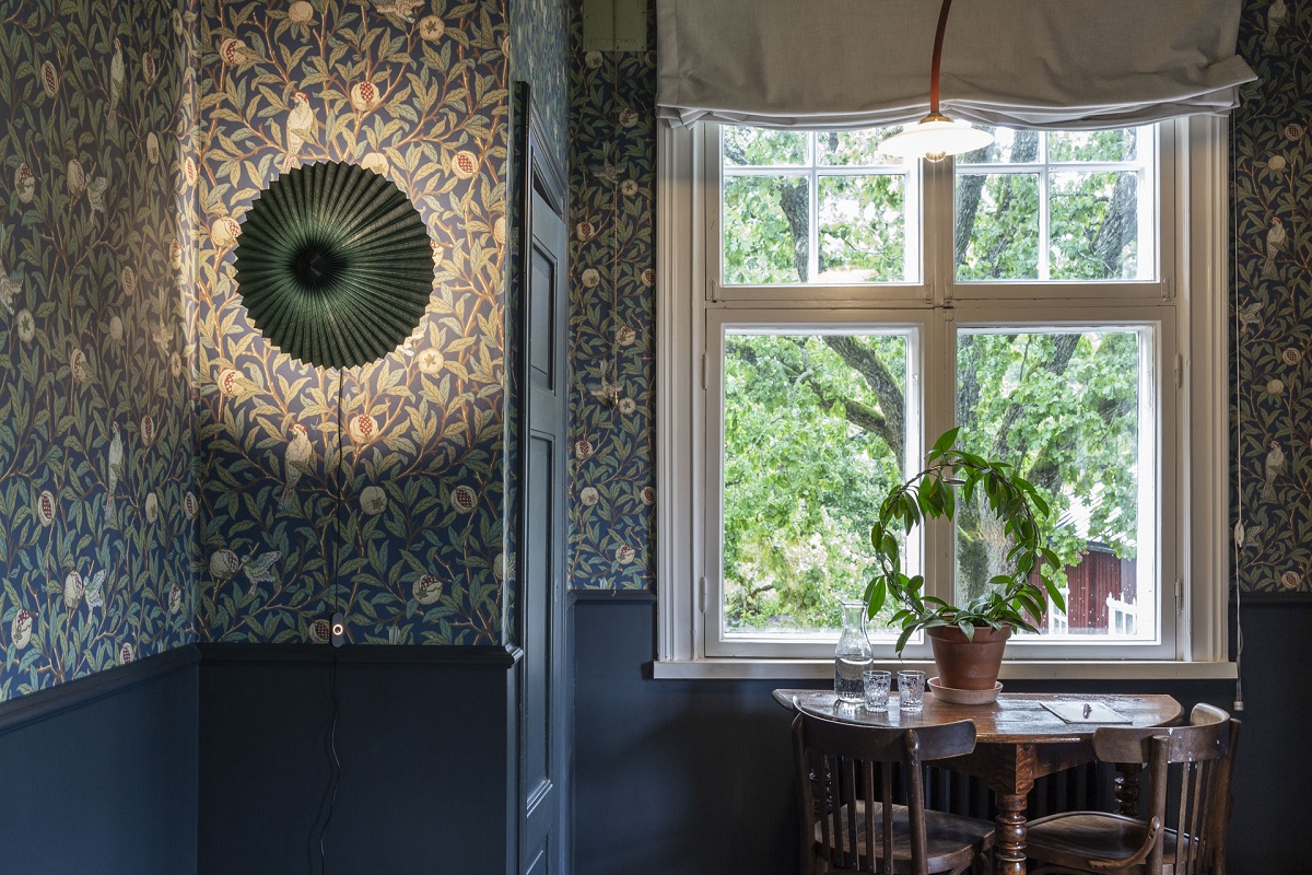 morris wallpaper and a sash window with a plant