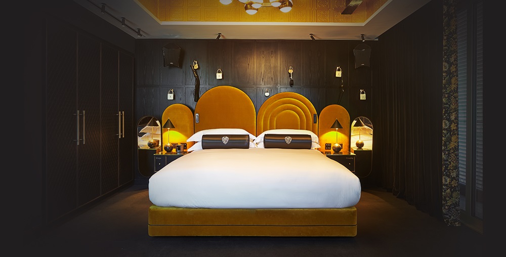 mattison contract bed in hotel with yellow upholstered headboard