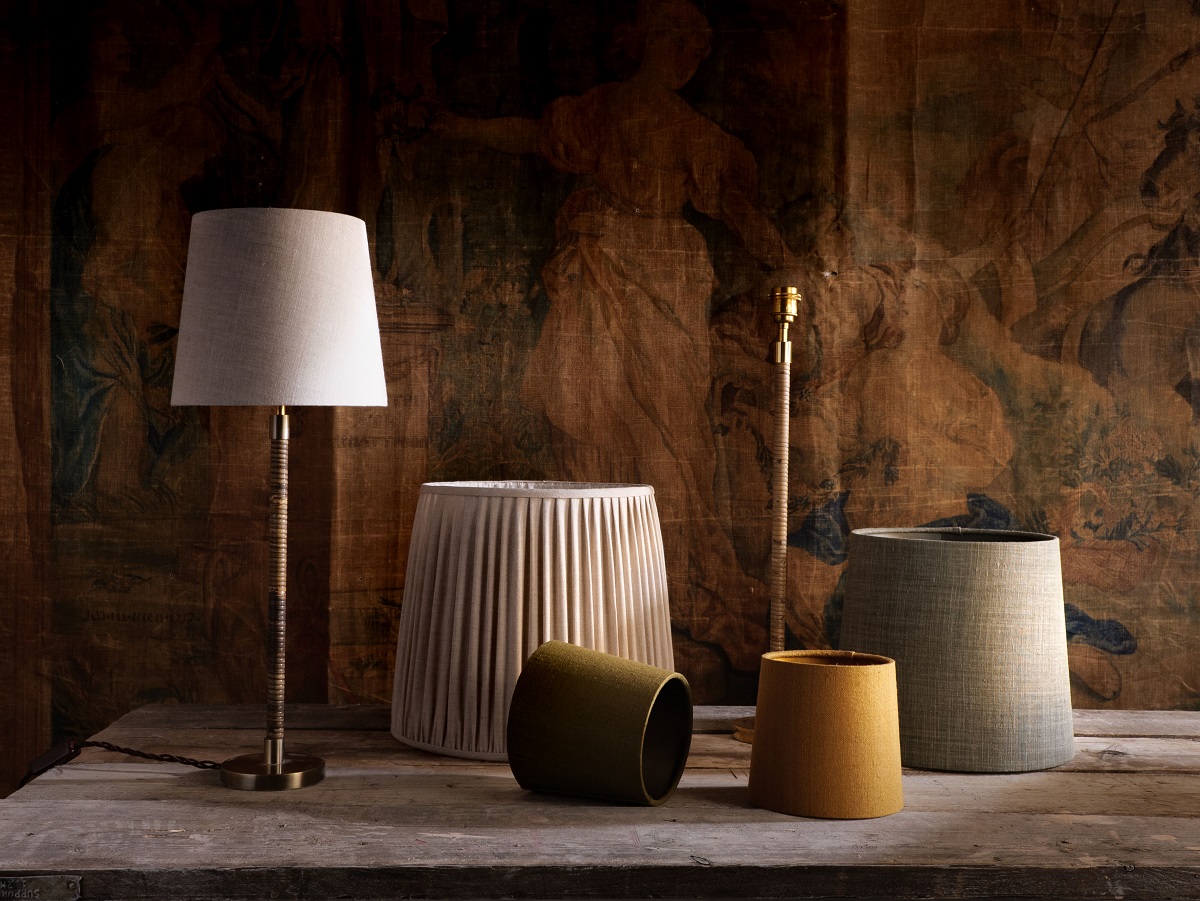 A selection of Porta Romana lampshades against a dark backdrop shows shades in various sizes and colours