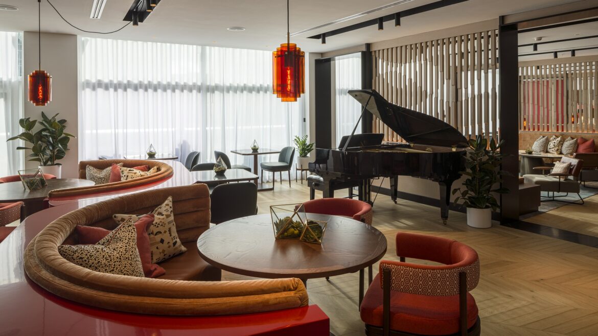 Piano and seating in Lowry Hotel Bar with wooden flooring