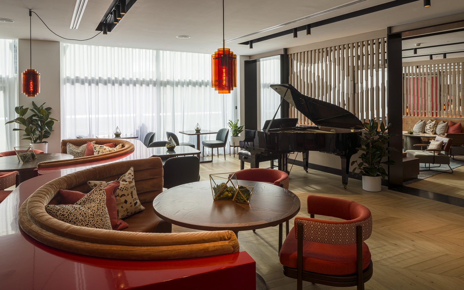 Piano and seating in Lowry Hotel Bar with wooden flooring