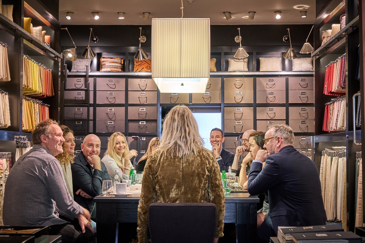 The group of designers engaging in the discussion round the table at the Dedar showroom