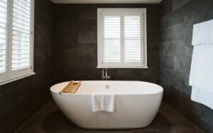 white freestanding bath against slate grey tiles in Petersham Hotel