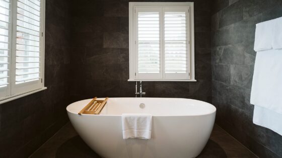 white freestanding bath against slate grey tiles in Petersham Hotel