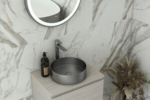 RAK round brushed nickel basin in marble tiled bathroom