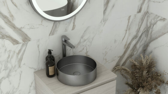 RAK round brushed nickel basin in marble tiled bathroom