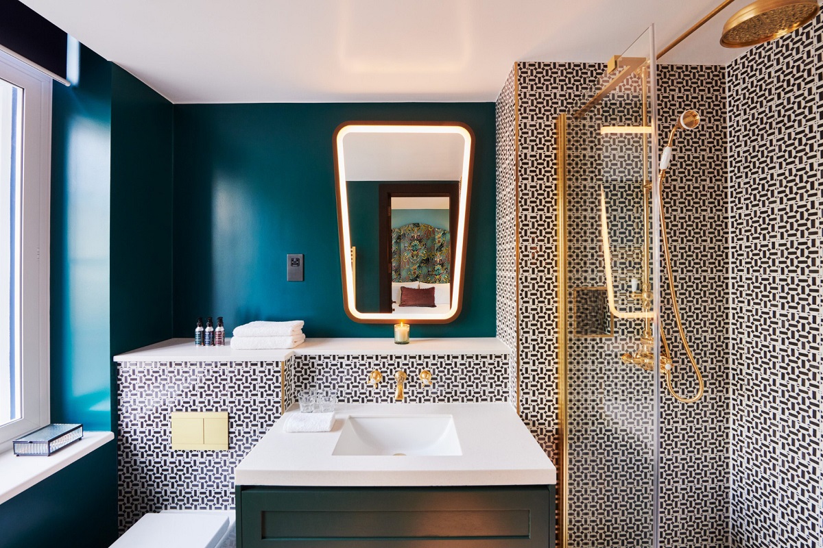 blue walls and patterned tiles in ensuite bathroom The Other House