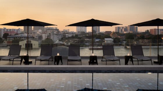 pool and parasols at dusk at The StandardX, Bangkok Phra Arthit