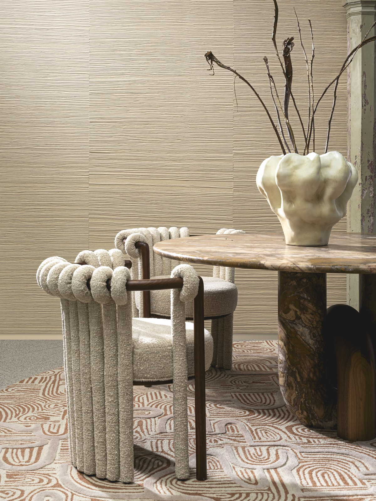 natural wallcovering from Arte with ceramic vase, stone table and textured chairs