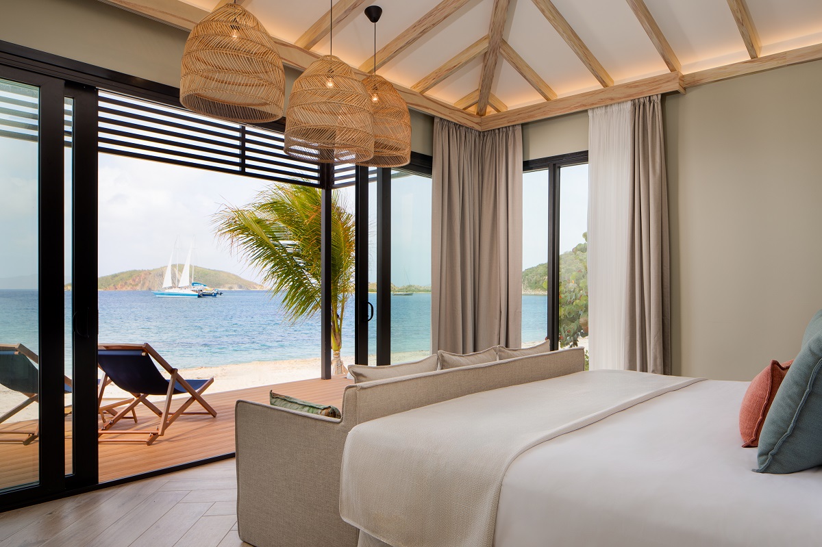 Peter Island Resort guestroom with sea view from bed