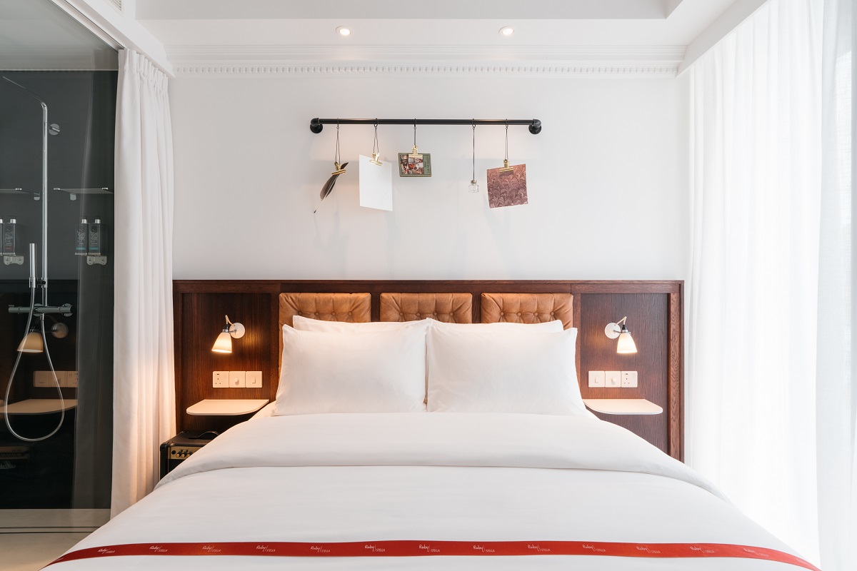 Ruby Stella guestroom with literary mobile of book pages above the bed