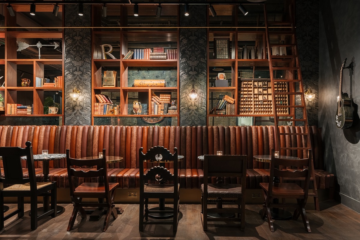 leather 'bookend' banquette seating and bookshelves in Ruby Stella