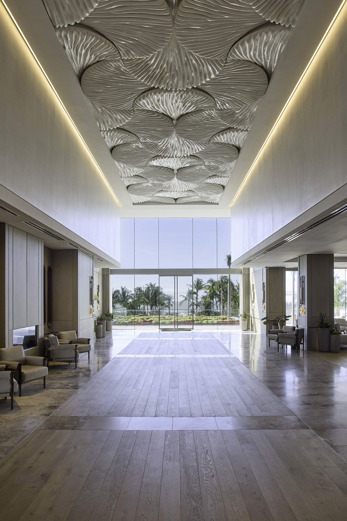 recessed lighting and textured ceiling in entry gallery design of St Regis by HBA