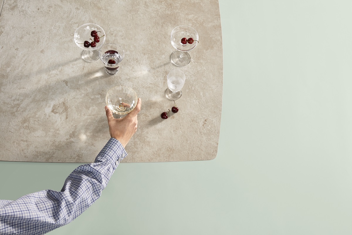 ceramic counter surface with hand on glass with cherries