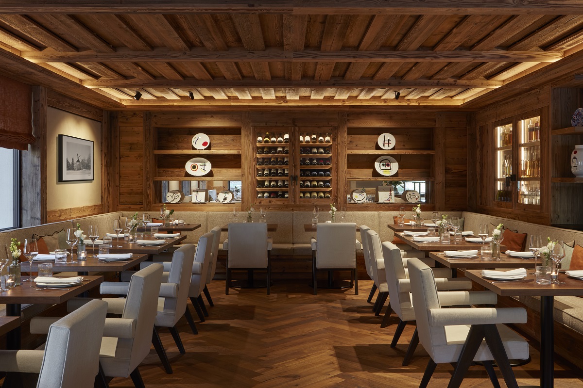 tables and chairs, wooden floor and ceiling and colurful ceramics in the restaurant at The Mansard