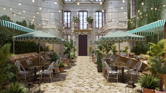 striped parasols and fairylights in the courtyard of Le Jardin de Verre Paris by Locke