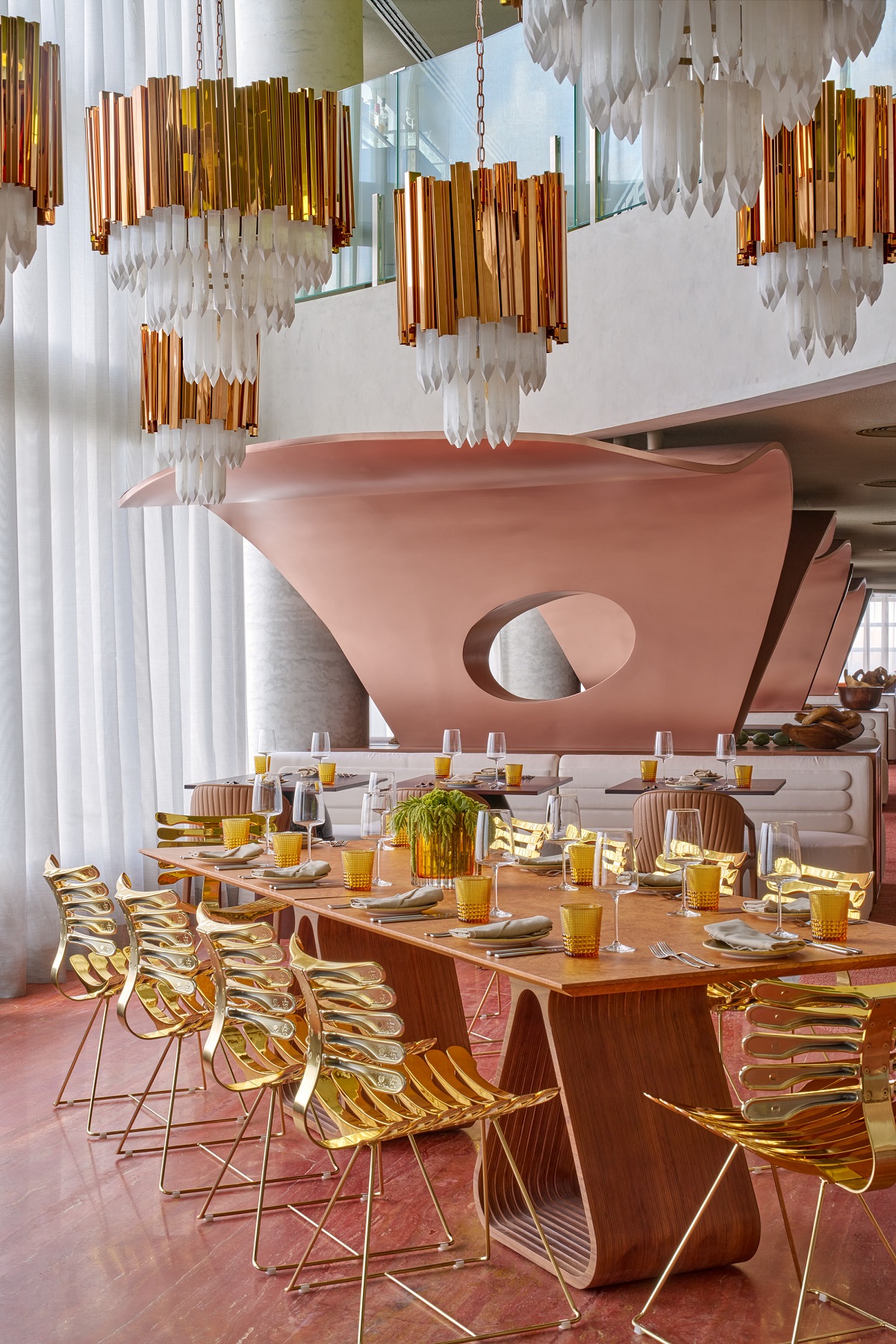 statement chandeliers, gold chairs and pink surfaces in W São Paulo