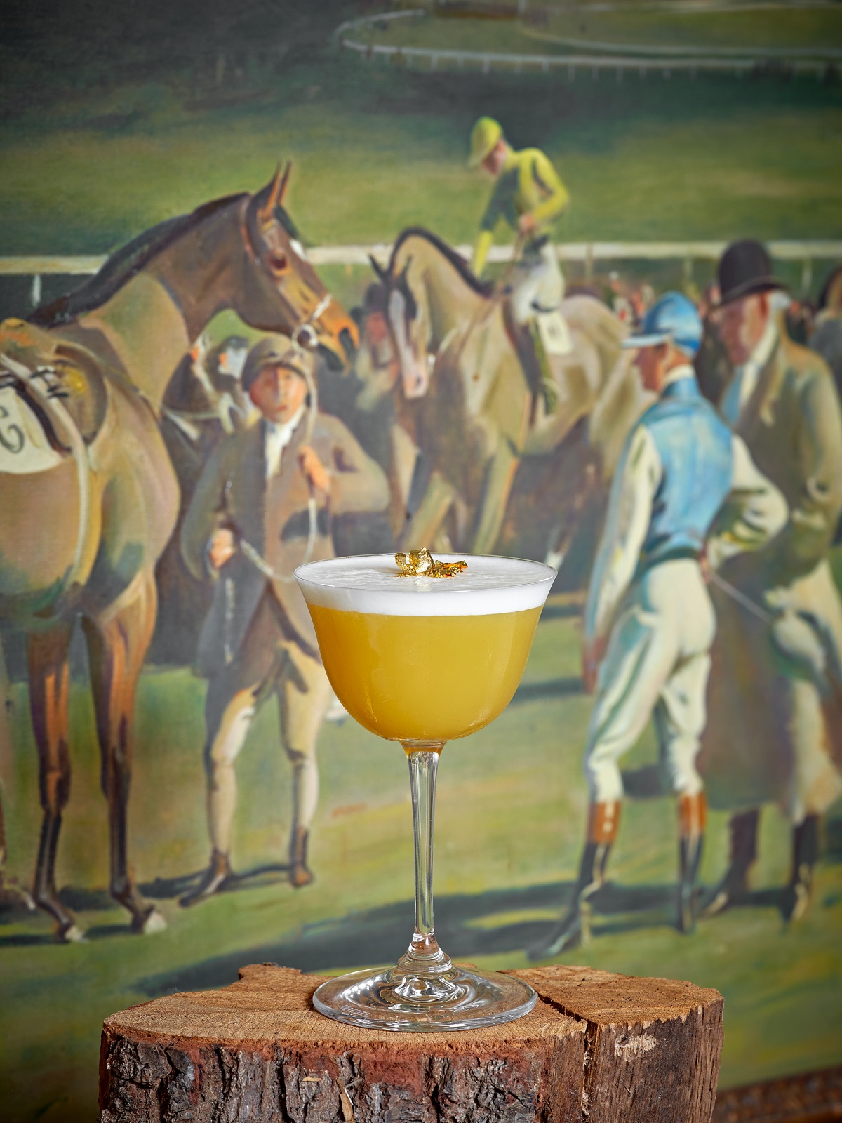 cocktail with horse racing painting as backdrop