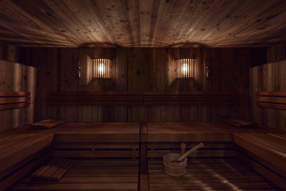 low lighting and wooden surfaces in the sauna room in The Mansard Gstaad