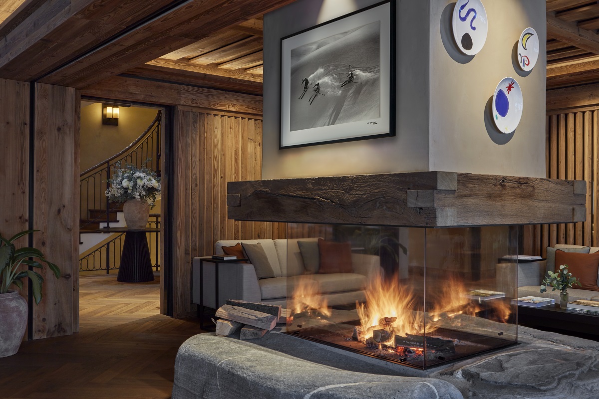 central open fireplace in lounge with seating and wood panelling