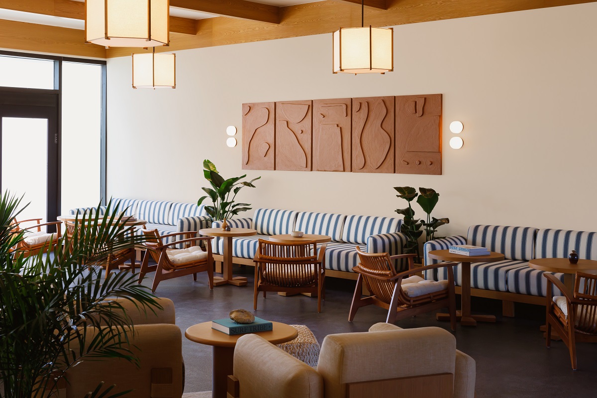 blue and white striped furniture and plants in hotel lobby Trailborn Surf & Sound