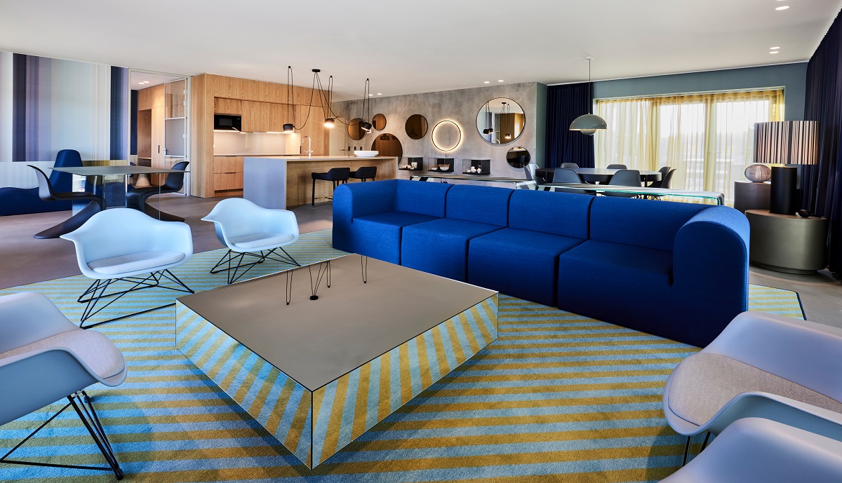 blue couch and yellow striped carpet in Kirk Suite apartment