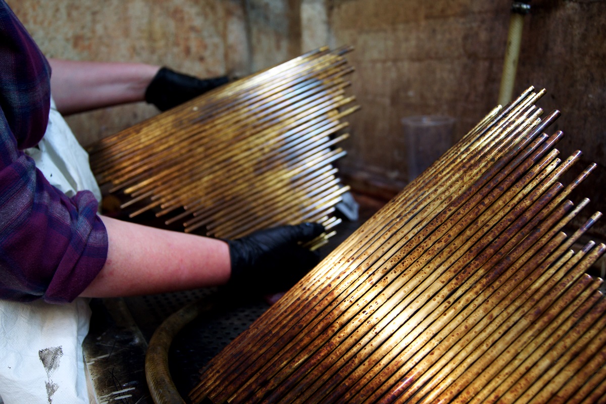 metal work for lights being done by hand in workshop