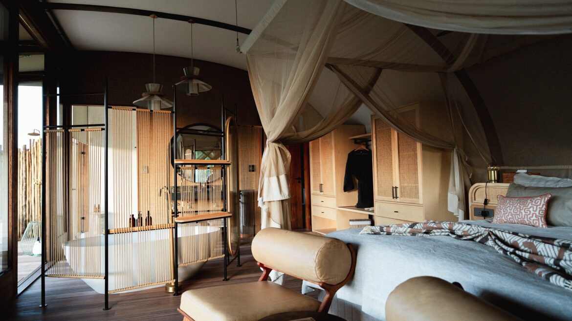 safari lodge bedroom and ensuite with canopy over bed and freestanding bath