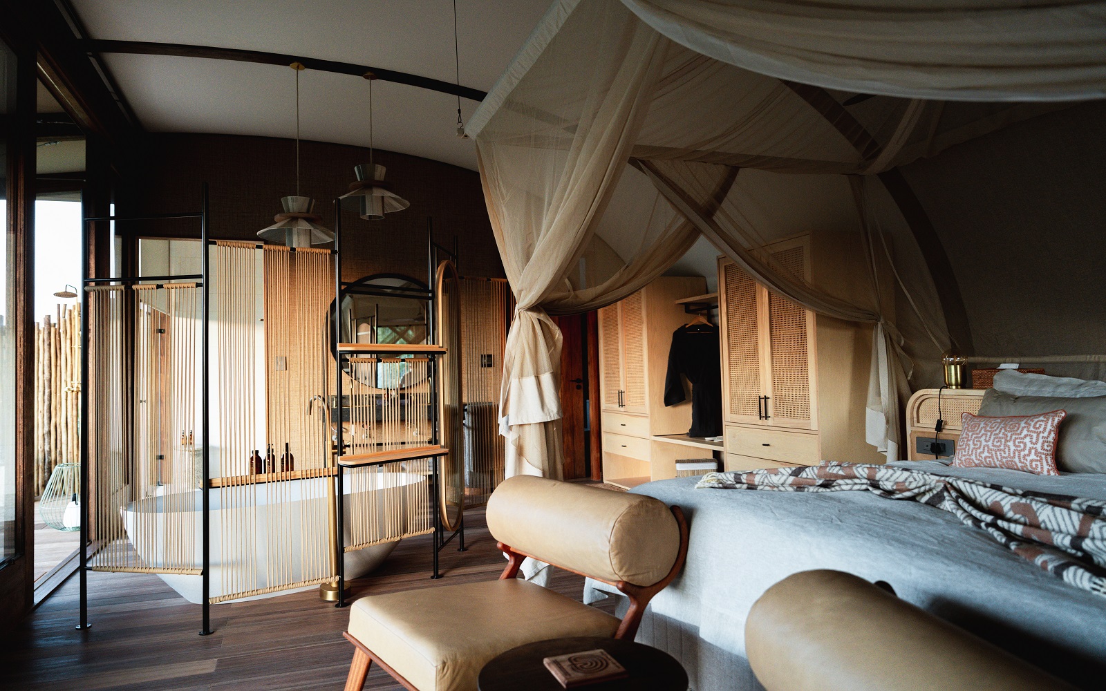 safari lodge bedroom and ensuite with canopy over bed and freestanding bath