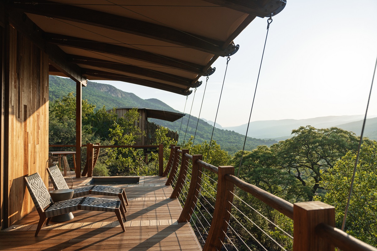 wooden deck in safari lodge overhanging trees and landscape