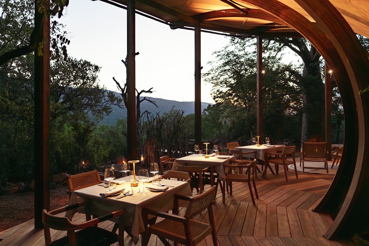 curved wooden structure over dining area in safari lodge