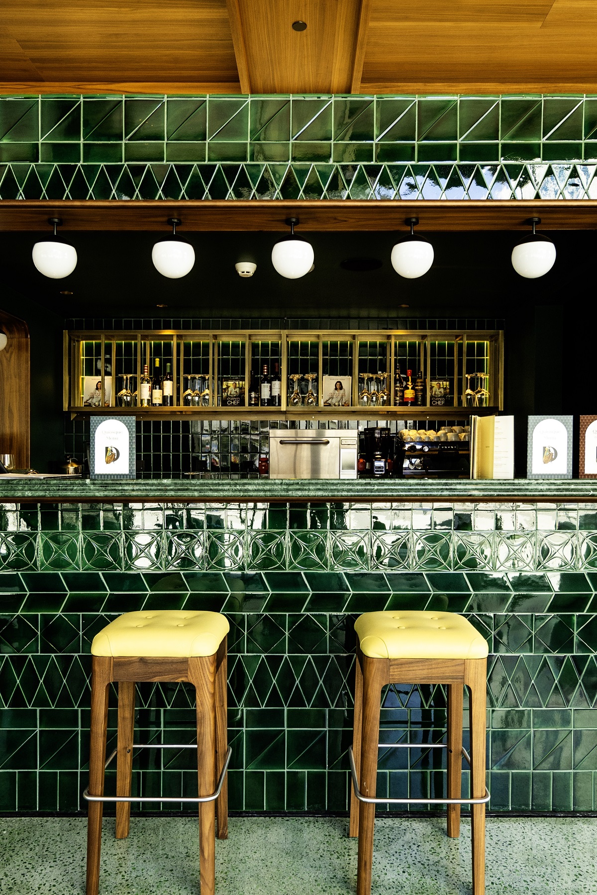 green tiles on bar with bar stools