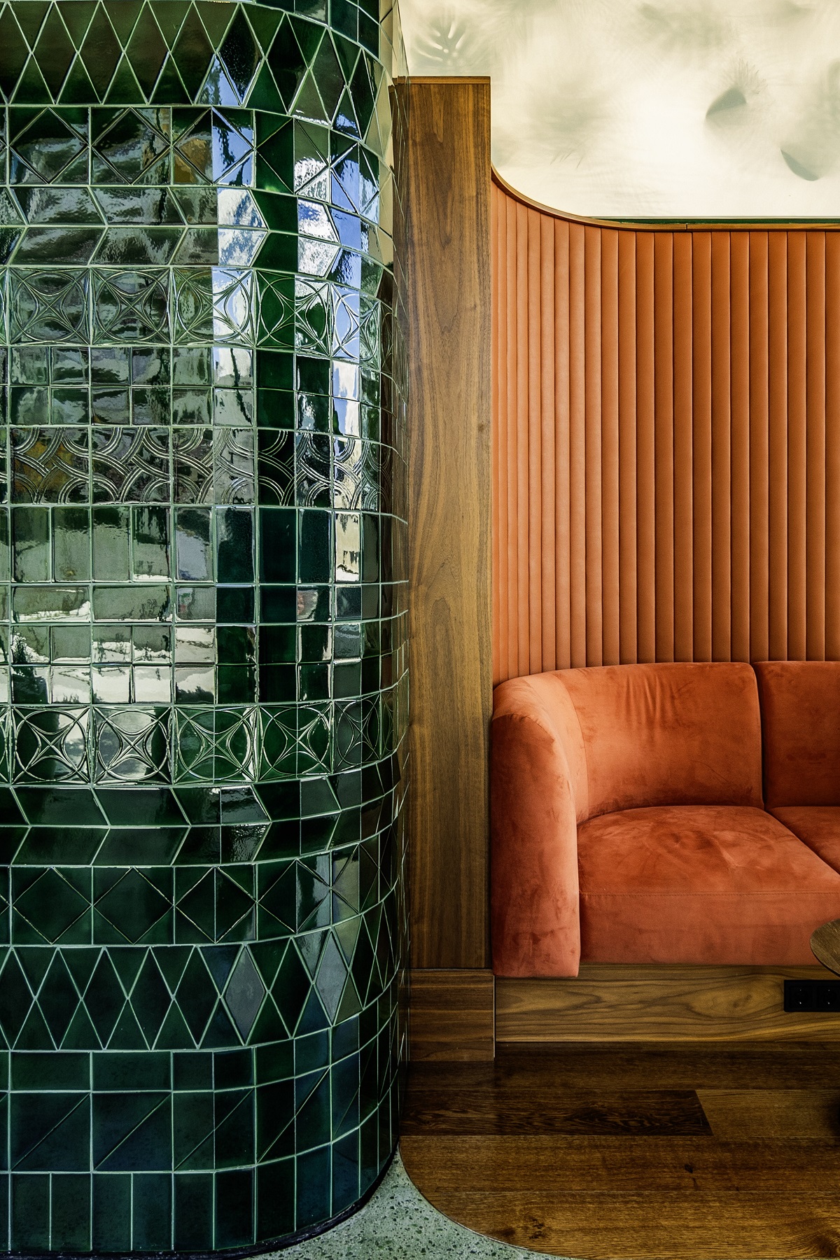 orange banquette and green tile detail