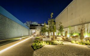 outdoor lighting, planting and seating between the two buildings of Hotel DUO Boavista