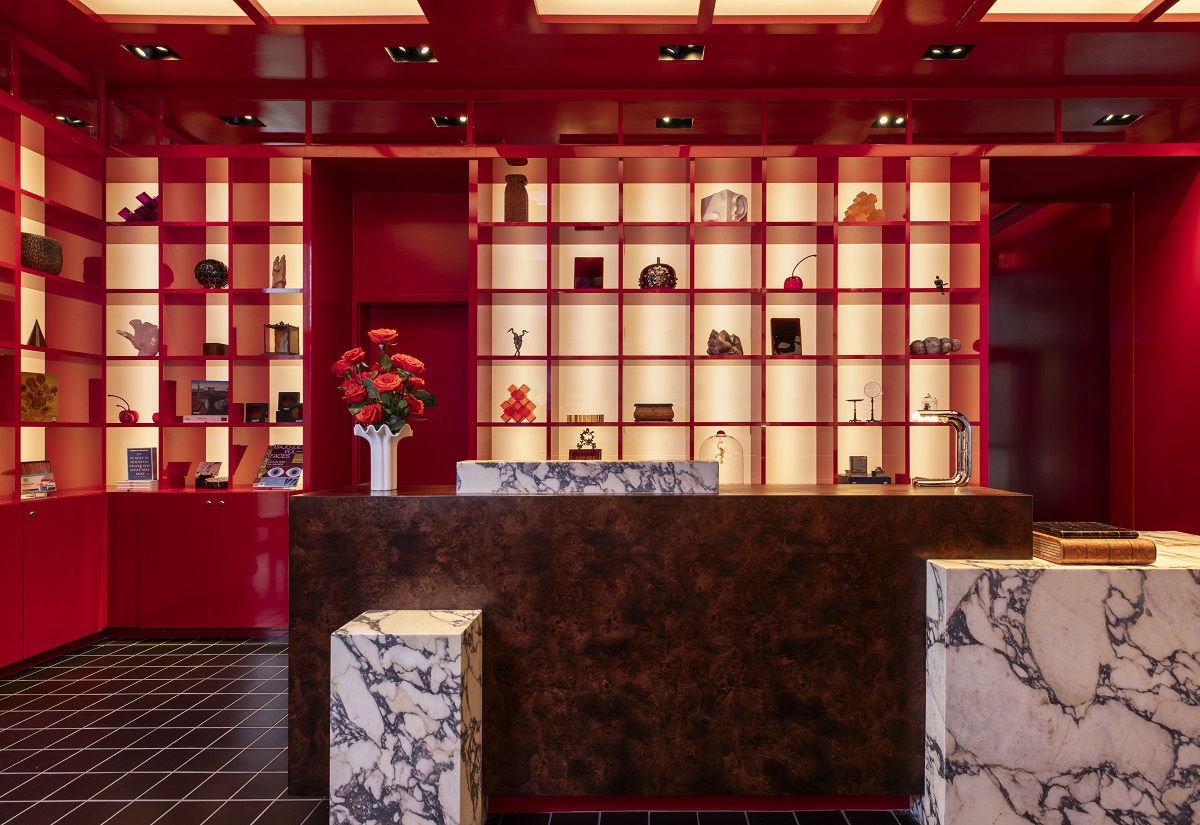 red lobyy with display shelving, marble and walnut surfaces