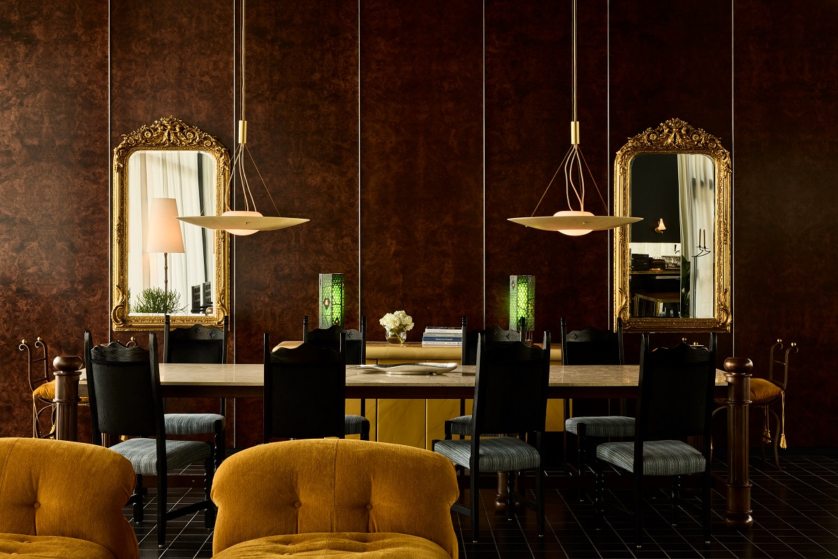 dark walls with mustard velvet chairs and gold mirrors in hotel lobby Hotel Saint Augustine