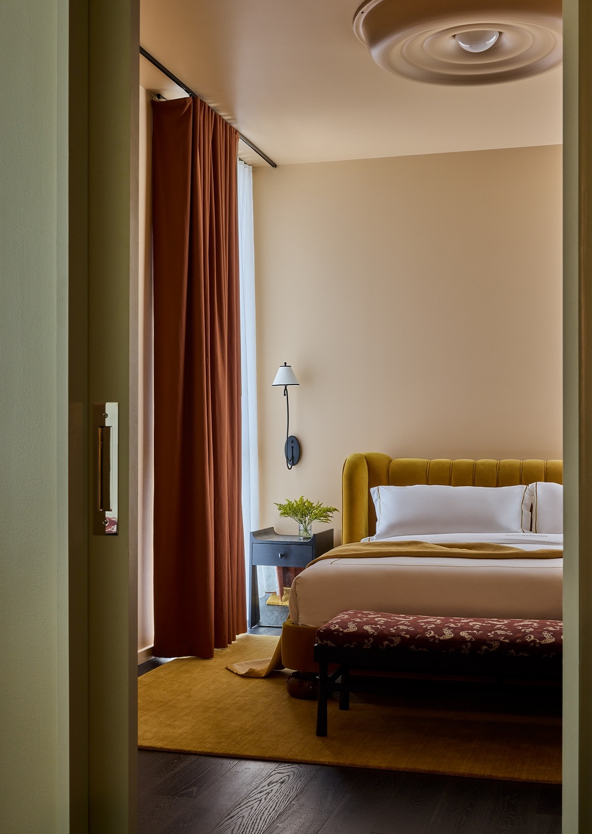 view of ochre and orange bedroom design in atelier suite of Hotel Saint augustine