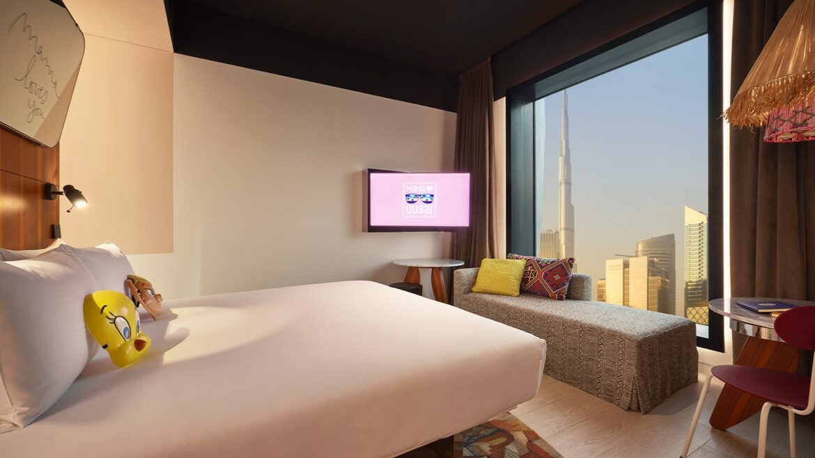 Mama Shelter guestroom with view over Dubai skyline from the bed