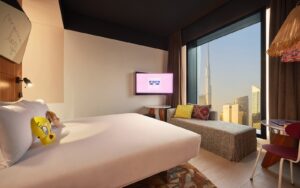 Mama Shelter guestroom with view over Dubai skyline from the bed