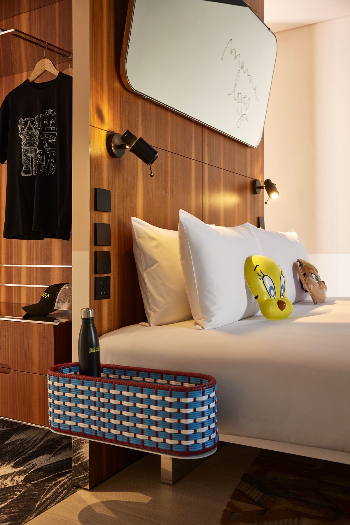 bed and sidetable detail in guestroom with signature Mama Shelter design elements