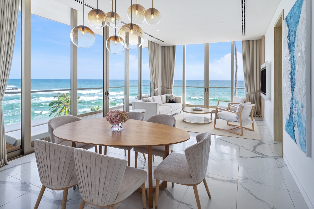 marble floor and floor-to-ceiling windows with seaview from dining table in hotel suite