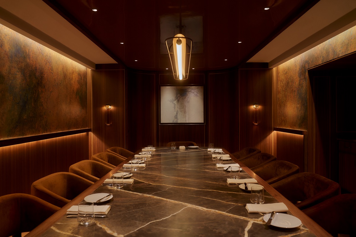 warm colours, architectural lighting and rich surfaces in private dining area of restaurant